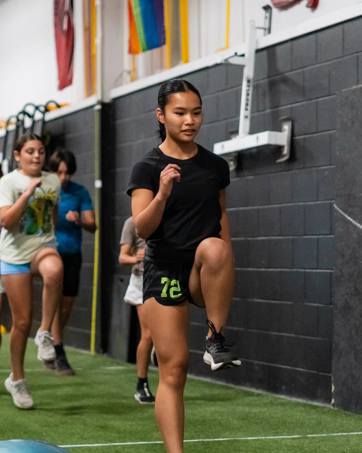 Teen athletes practising sprint mechanics on the CANAM turf