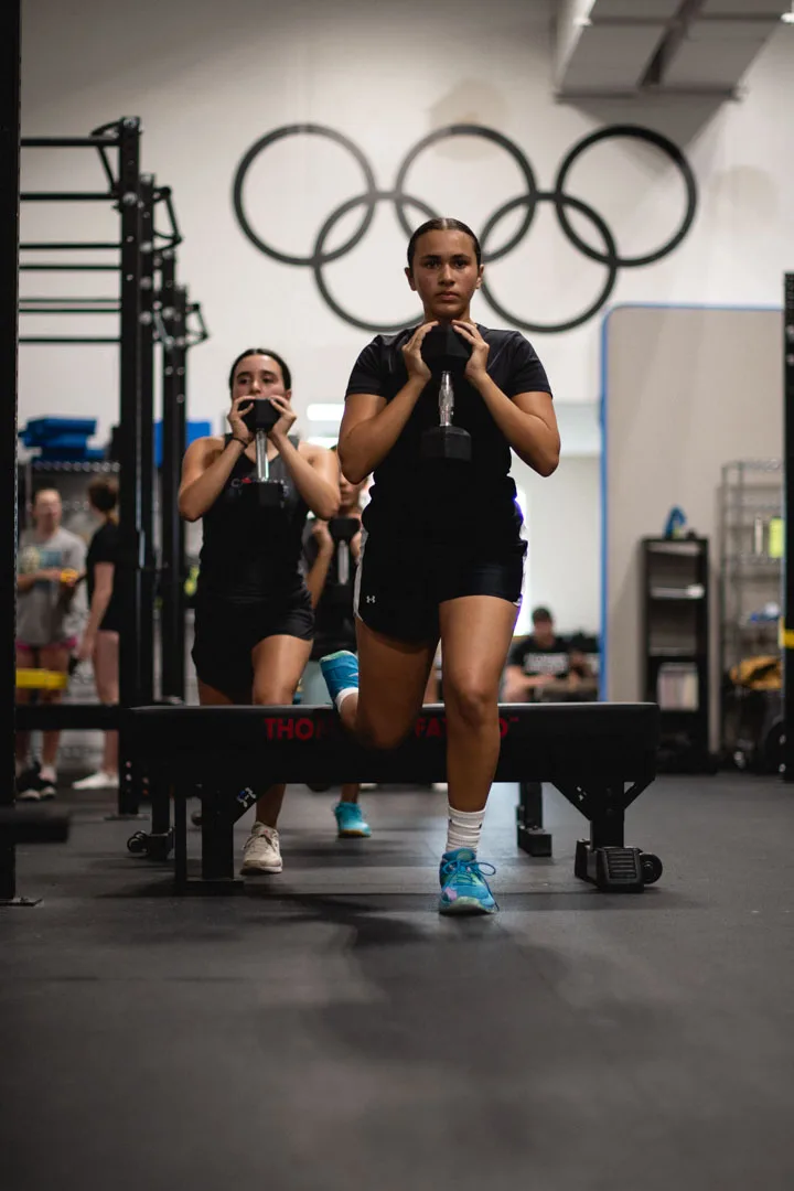 Teen athletes practising weighted split squats at CANAM